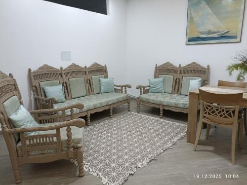 a room with several chairs and a table and a table with a table at Résidence Debbabi in Monastir