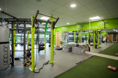 a gym with green walls and yellow poles at Bannatyne Hotel Darlington in Darlington