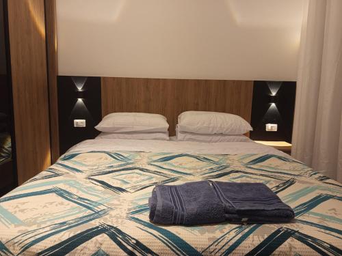 een bed met een handdoek erop. bij Golf Heights Resort Nabk Bay Sharm El Sheikh One Bedroom Apartment in Sharm El Sheikh