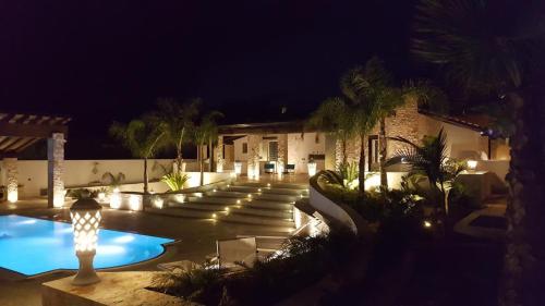 een huis met een zwembad in de nacht bij Villa Nazarena in Torre Suda