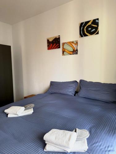 een blauw bed met twee witte handdoeken erop bij Apartment und Ferienwohnung Scharnhorststraße, Berlin-Mitte in Oranienburg