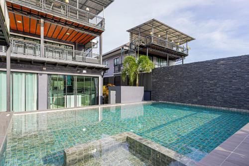 a swimming pool in the middle of a house at Kathu V pool villa 171 in Kathu