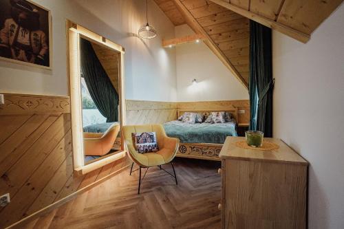 a small bedroom with a bed and a mirror at Krzeptówki House in Zakopane