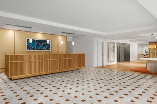 a large lobby with a waiting room with a counter at Sabàtic Gavà Mar, Barcelona, a Tribute Portfolio Hotel in Gavà