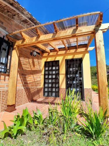 a pergola over a patio of a house at Villa El Colibri in El Peñol