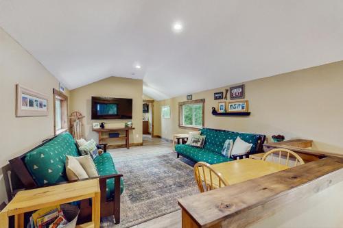 a living room with a couch and a table at Bear Creek Cabin in Government Camp