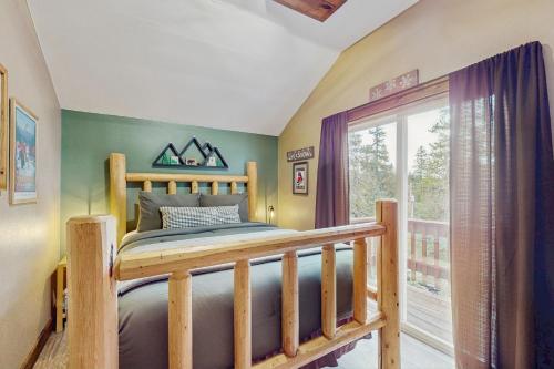 a bedroom with a wooden bed and a window at Bear Creek Cabin in Government Camp