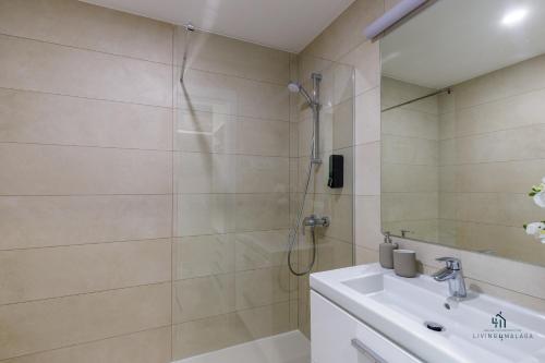 a bathroom with a shower and a sink at Living4malaga Tower Horizon in Málaga