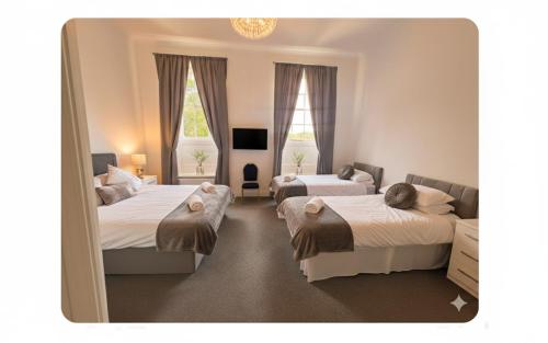 En eller flere senge i et værelse på Manor Park Country House