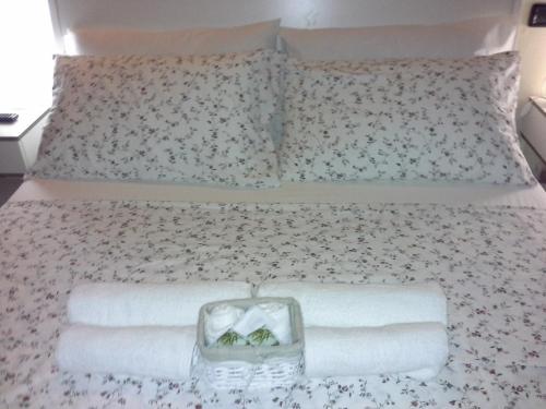 a bed with two pillows and a tray of towels at B&B Happiness in the Country in Brescello