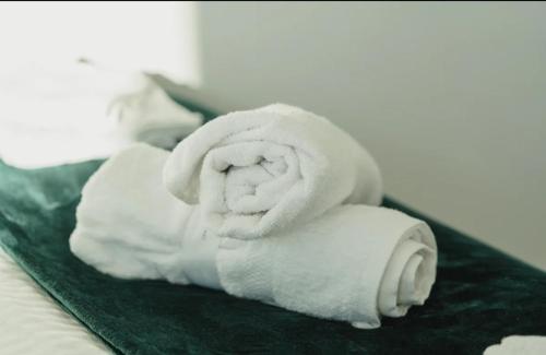 a pile of white towels sitting on a bed at Birmingham Central NewStreet 1Bed in Birmingham