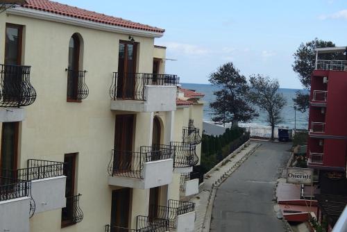 an apartment building with balconies and a street at Sea'n'Pool Apartments in Hotel in Sozopol