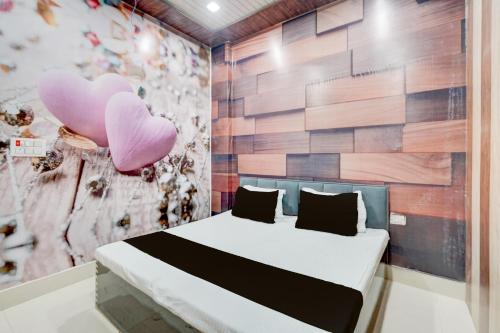una camera da letto con un letto con cuori rosa sul muro di SPOT ON The Yeble Hotel And Restaurant a Etāwah