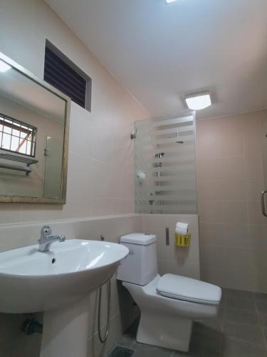 a bathroom with a sink and a toilet and a mirror at Sentul KL Private Cozy Bungalow Homestay - Free Parking & Wifi in Kuala Lumpur