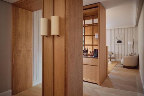 een woonkamer met een scheidingswand met een glazen deur bij The Florentin by Althoff Collection in Frankfurt am Main