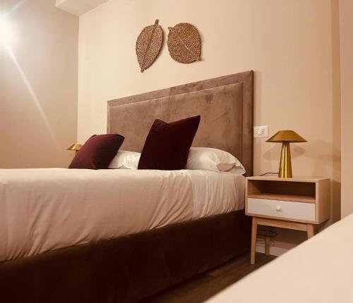 a bedroom with a bed with two pillows and a night stand at Gatto Bianco Carulli in Bari