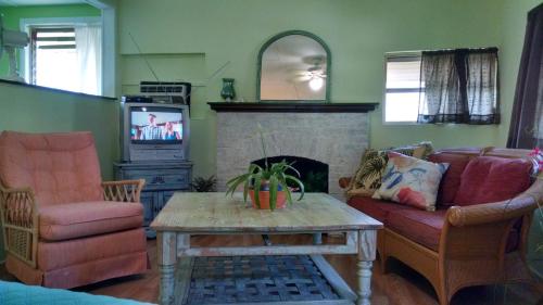 a living room with a couch and a fireplace at 1 Beige Cozy Bungalow or 1 White Cozy Efficiency Cottage in Titusville in Titusville