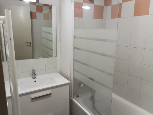 a white bathroom with a sink and a shower at Chalets de L Isard D N35 2P6 in Les Angles