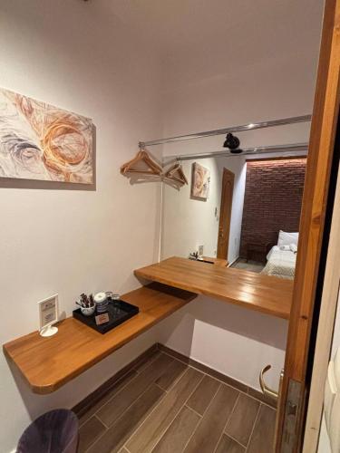 a room with a wooden desk and a mirror at Tzovolos Apartments in Kalavrita