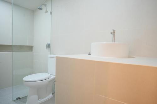 a bathroom with a sink and a toilet at INSAHAUS Guest House in Kotalama