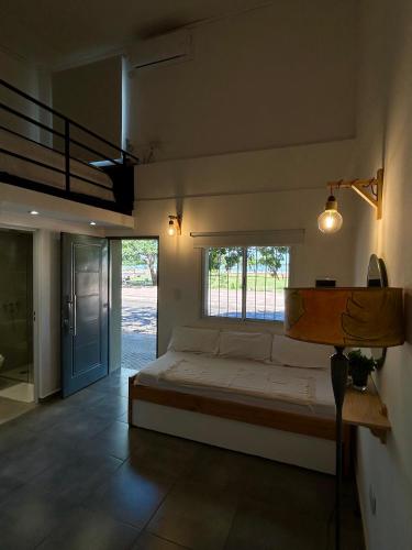 a bedroom with a large bed and a window at Loft Costanera in Posadas