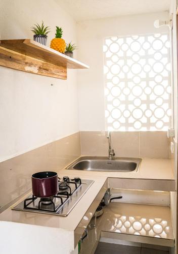 a kitchen with a stove and a sink at Apartaestudio Privado con cocina in Palomino