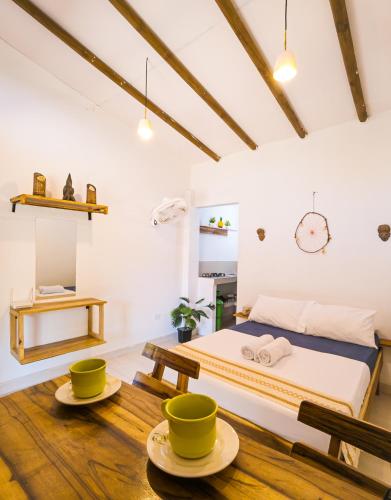 a bedroom with a bed and two bowls on the floor at Apartaestudio Privado con cocina in Palomino