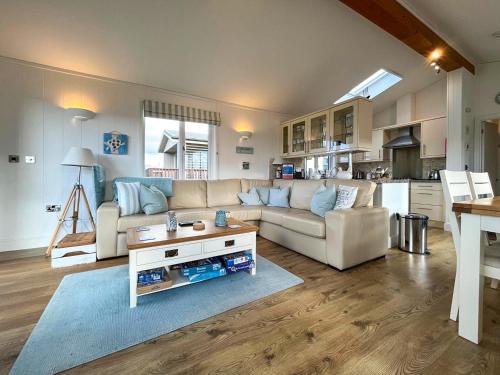 a living room with a couch and a table at 19 Salcombe Retreat in Salcombe