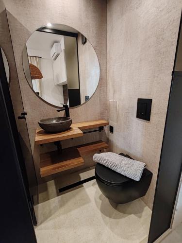a bathroom with a sink and a mirror at SOHO apartments in Burgas