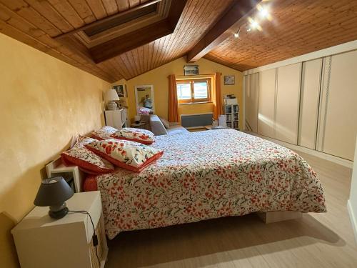a bedroom with a large bed in a room at LES JARDINS DE CARIBOLE in Fourneaux