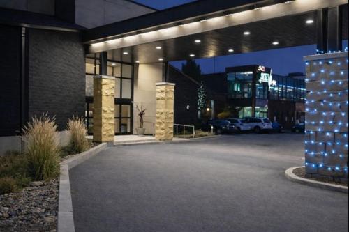 a building with a parking lot in front of it at Quality Inn & Suites in Gatineau