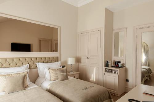 a bedroom with a bed and a large mirror at Boutique 19 Hotel in Baku