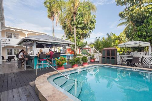 a pool at a hotel with people sitting at a bar at The Palms Hotel in Key West