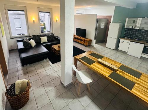 ein Wohnzimmer und eine Küche mit einem Tisch und einer Couch in der Unterkunft Stadtwohnung in Groß-Umstadt in Groß-Umstadt