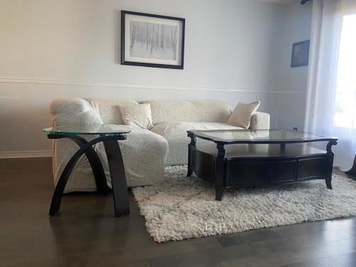 a living room with a couch and a coffee table at Napaeno's Place - Home Away from Home in Kingston