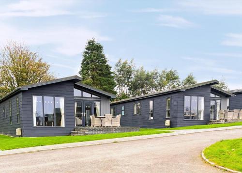 a black modular home with a driveway at Penally Grange in Tenby