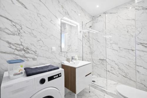 a white bathroom with a washing machine in it at Andromaches by Verde Apartments in Athens