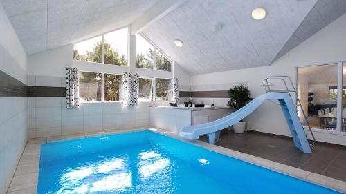 ein Pool mit Rutsche in einem Haus in der Unterkunft Villavilla #347 - Dueodde, Bornholm in Bedegård