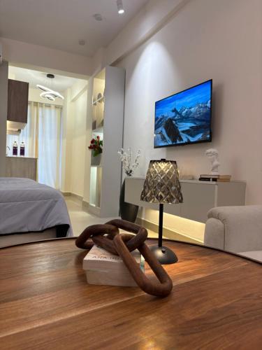 Zimmer mit einem Bett und einem Tisch mit einer Lampe in der Unterkunft The Elysian in Ghaziabad