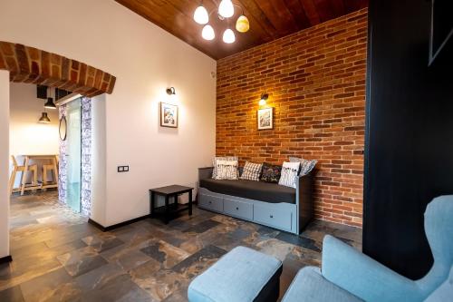 a room with a brick wall and two chairs at Apartamente Lux Unirii in Timişoara