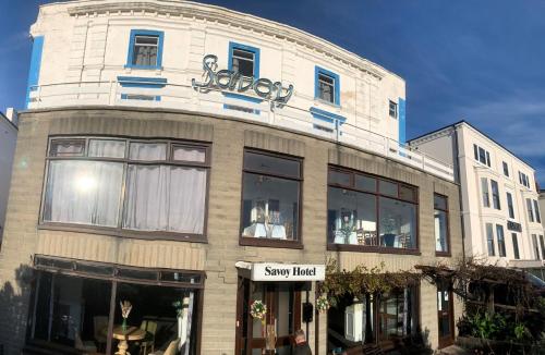 a large white building with a sign on it at Savoy Hotel in Weston-super-Mare