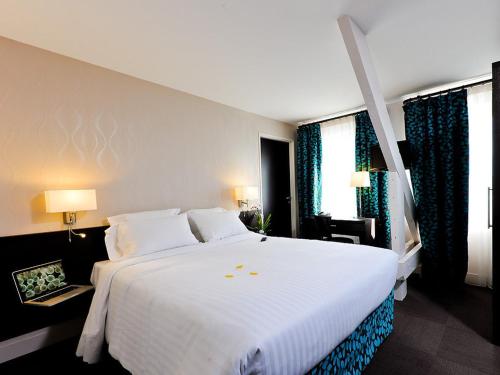 Postel nebo postele na pokoji v ubytování Le Saint-Pierre