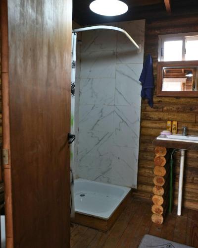 a bathroom with a shower with a tub and a sink at CABAÑAS BRUTUS RANCHs in Azul