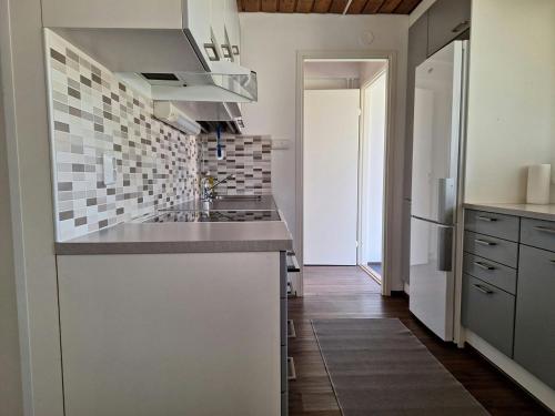 a kitchen with a sink and a stove at Spacious Apartment for 5 in Sodankylä