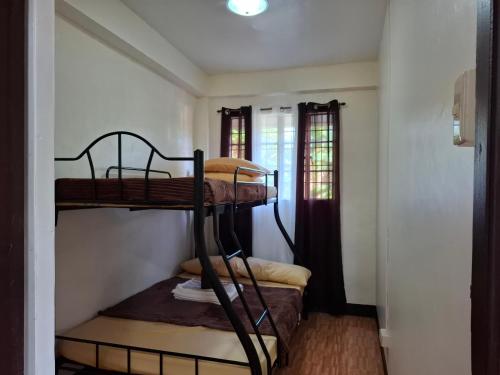 a room with two bunk beds in it at Balay Degay Transient House in Baguio