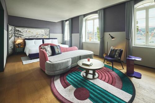 a living room with a couch and a bed at Hotel Indigo Nagasaki Glover Street by IHG in Nagasaki