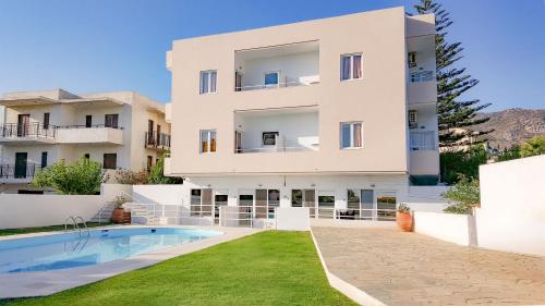 an apartment building with a swimming pool in front of it at Mastorakis Hotel and Studios in Hersonissos