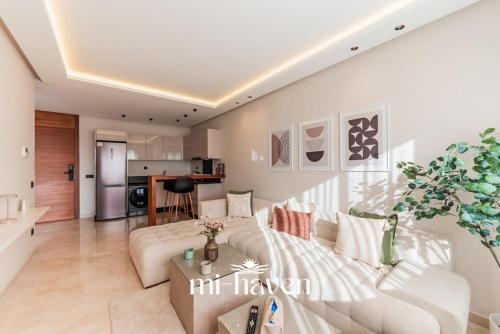a living room with a couch and a table at Aura - 1 BR - Premium Apartment in Maarif
