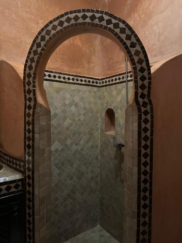 a shower with a glass door in a bathroom at Riad Jadis in Marrakesh