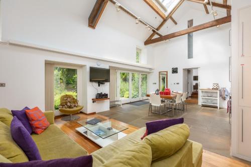 a living room with a couch and a table at The Barn at Noelles Cottages in Pickering